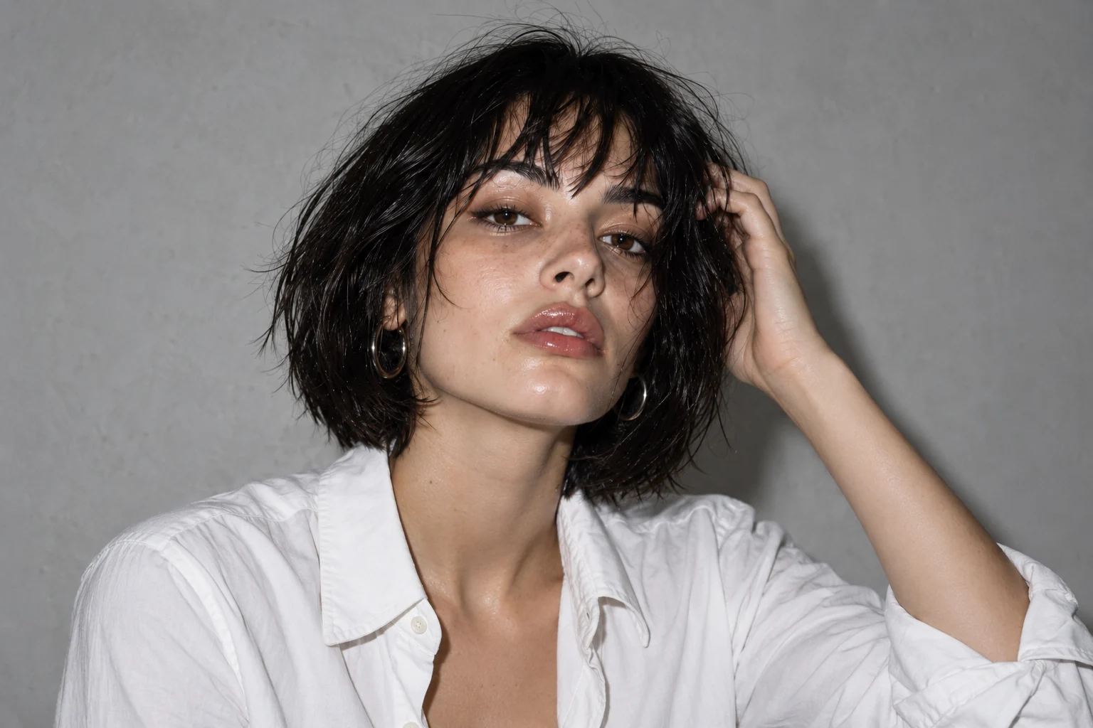 Flash Study portrait with a white shirt and relaxed hand near the hair